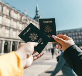 anonymous tourists showing us passports on street on sunny day